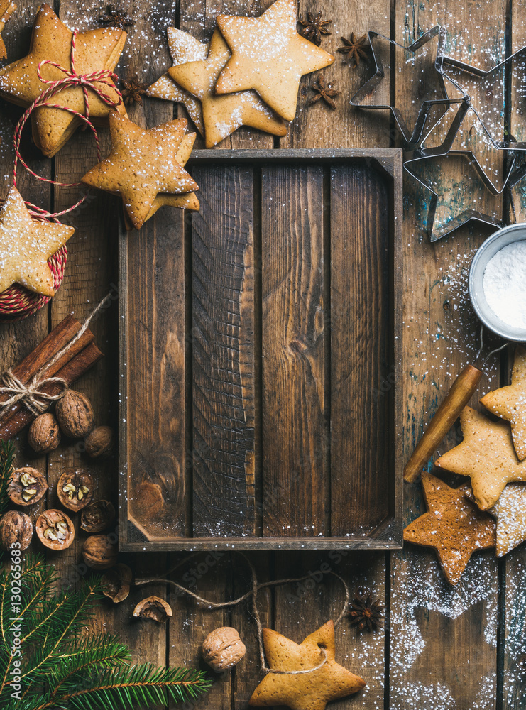 Christmas, New Year background. Gingerbread cookies, sugar powder, nuts, spices, baking molds, fir-t