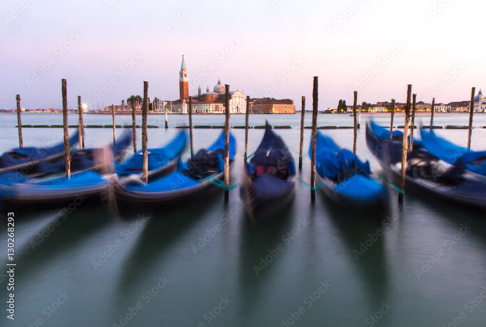 Long exposure of gondolas docked near St Marc square in Venice, Italy.