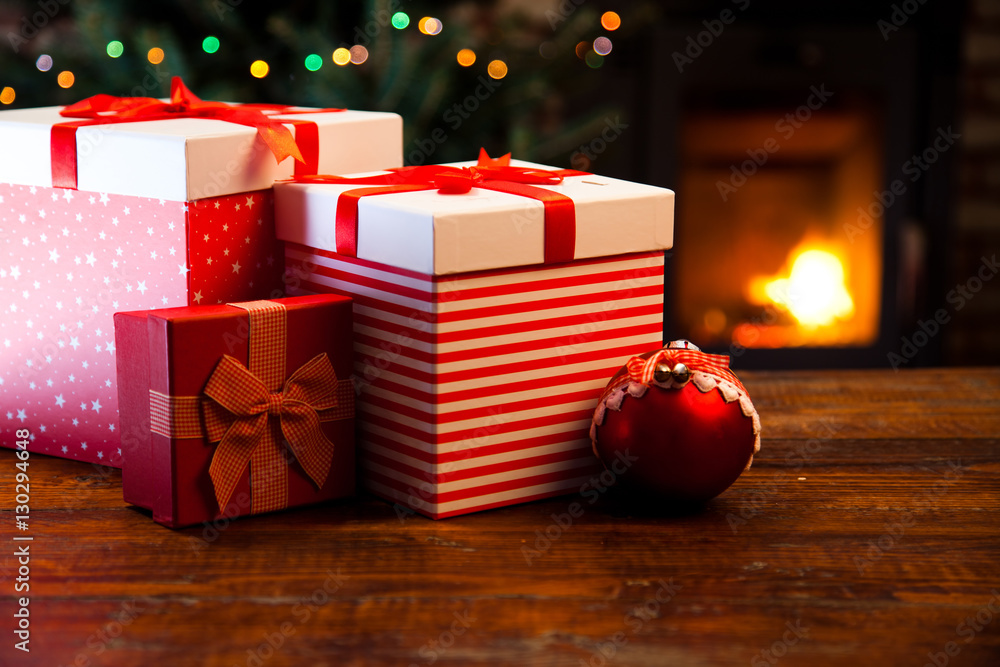 festive red Gift Boxes by the Burning Fireplace