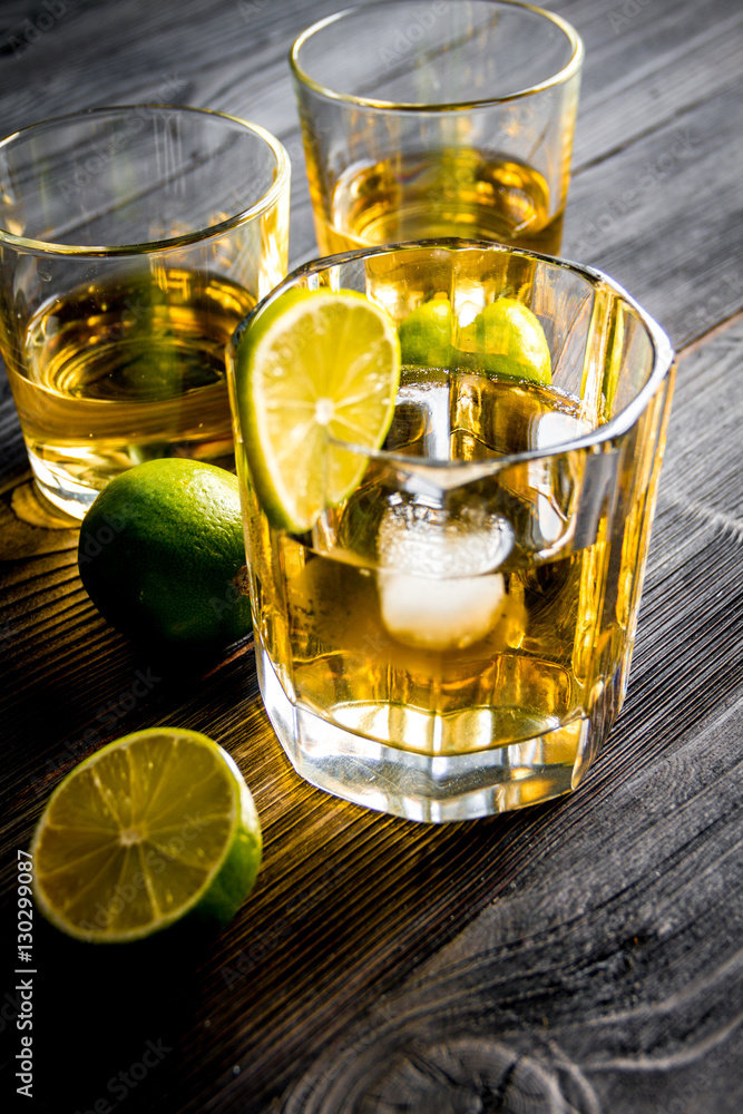 glass of whiskey on dark wooden background