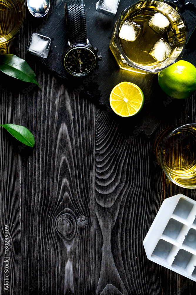 glass of scotch on dark wooden background top view