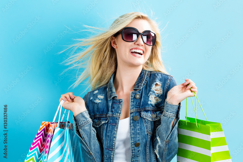 Happy young woman holding shopping bags