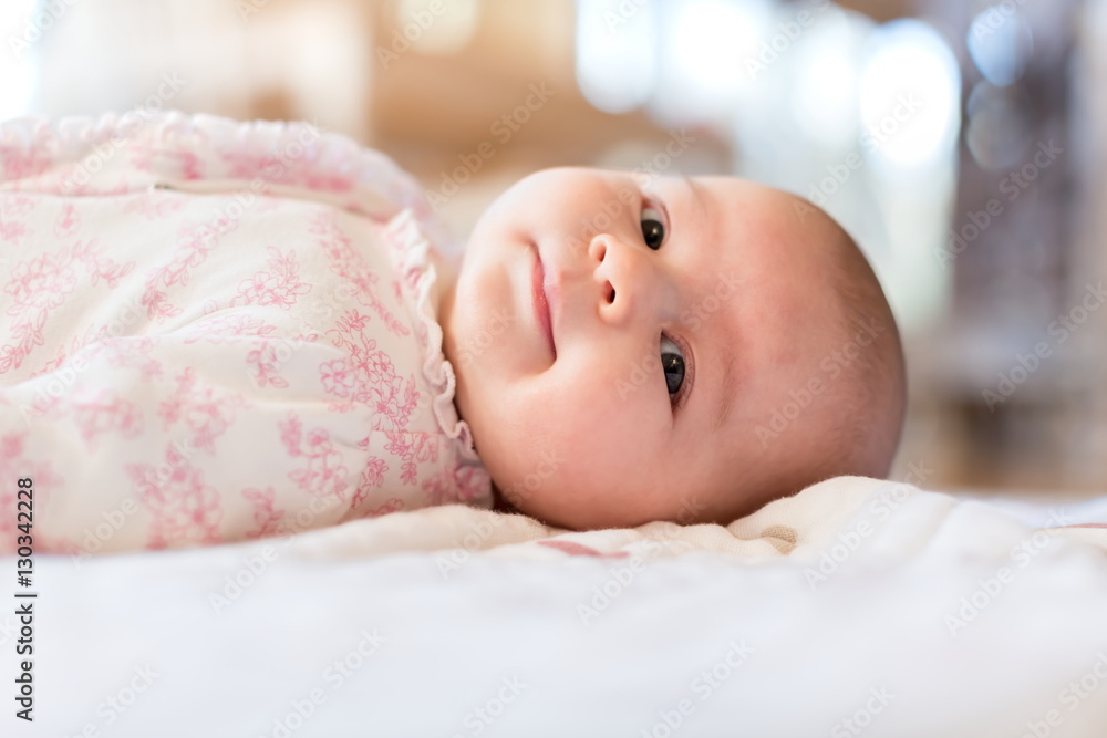 Baby girl lying on her blanket