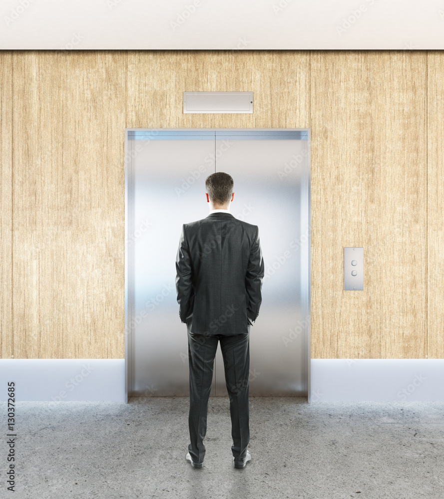 Man in interior with elevator