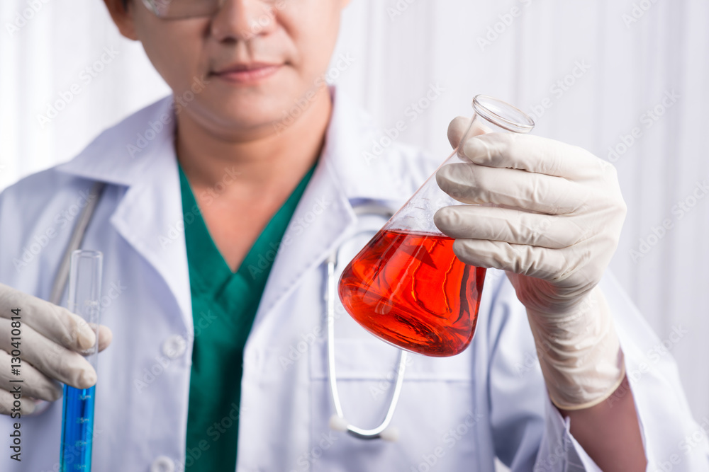 Male scientist holds and examine samples