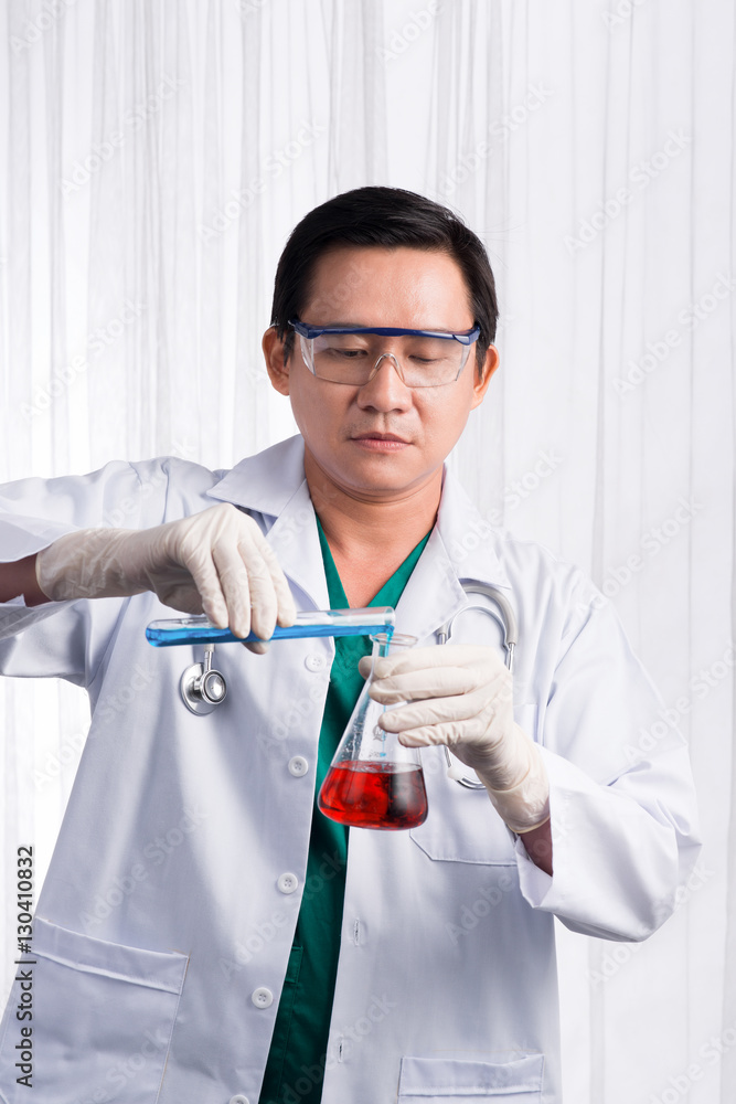 Male scientist holds and examine samples