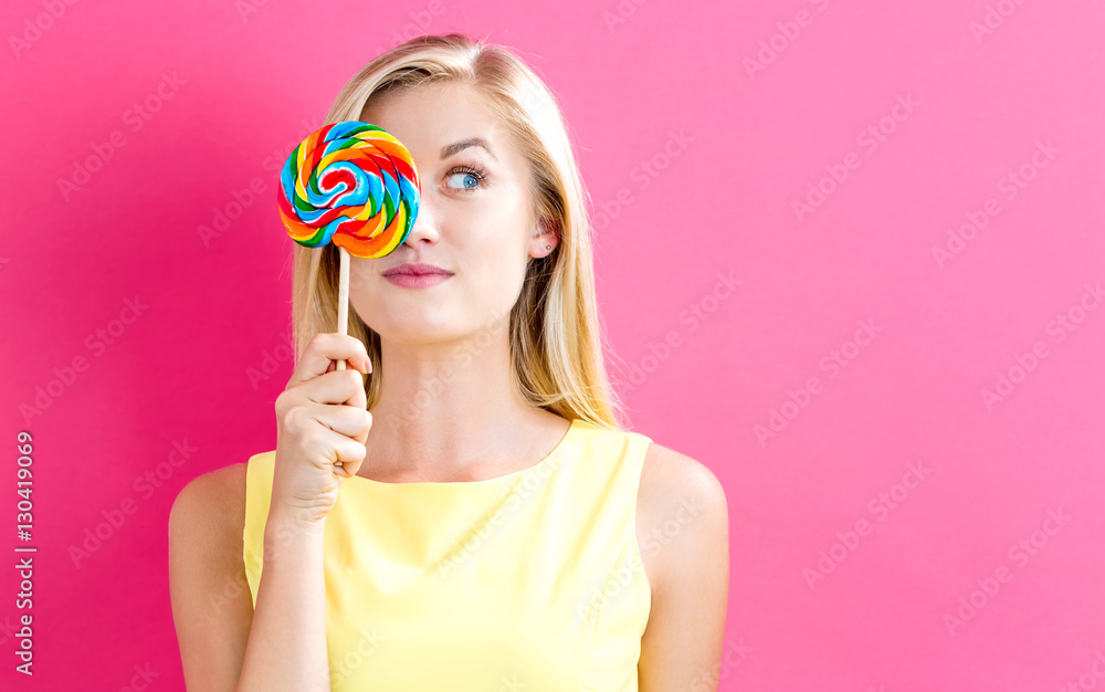 Young woman holding a lollipop