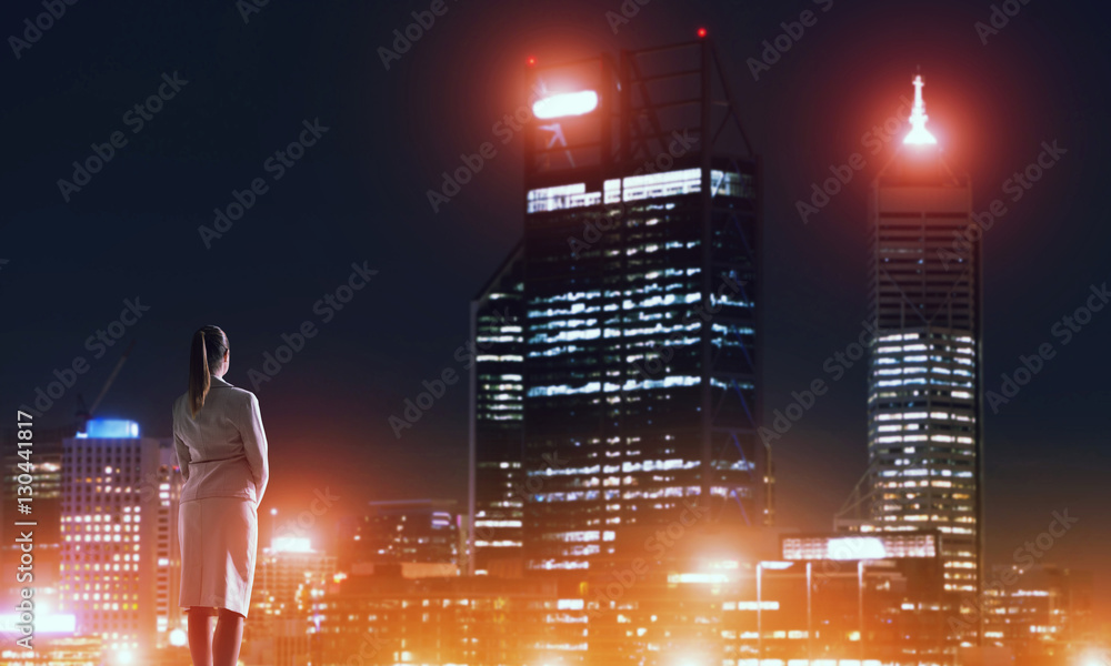 Woman looking at night city