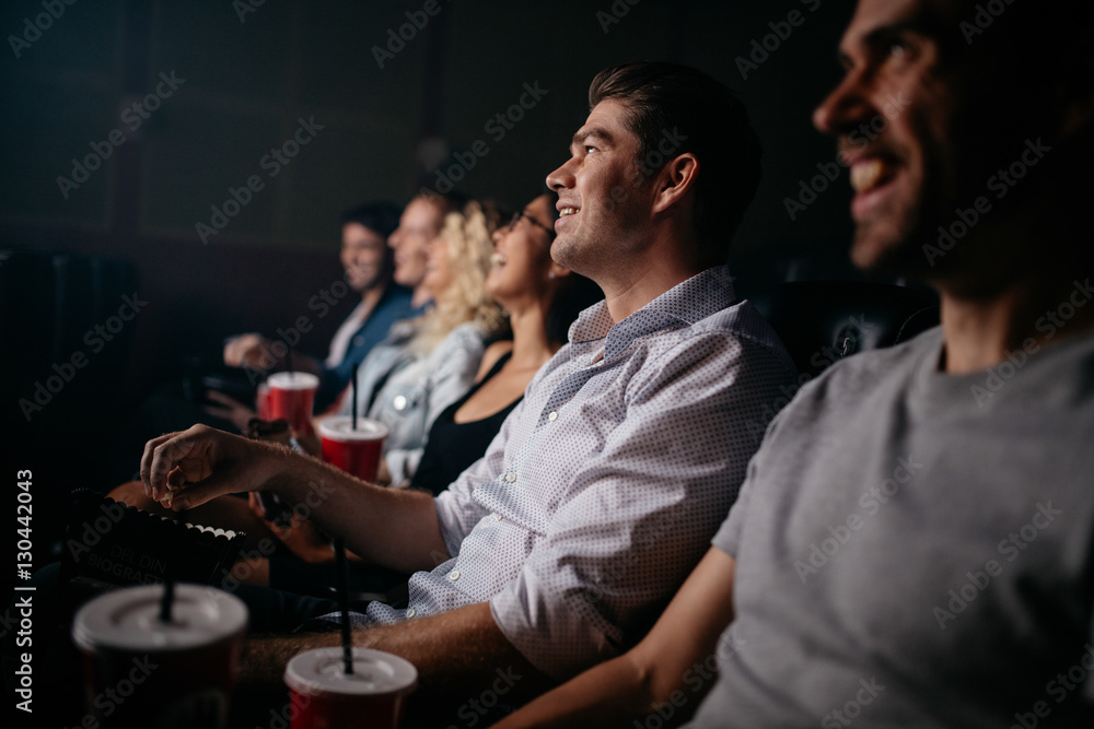 People sitting in cinema hall watching movie