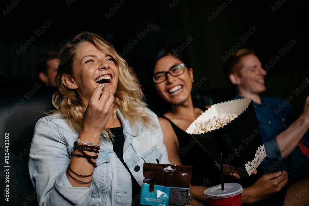 Young woman with friends watching movie