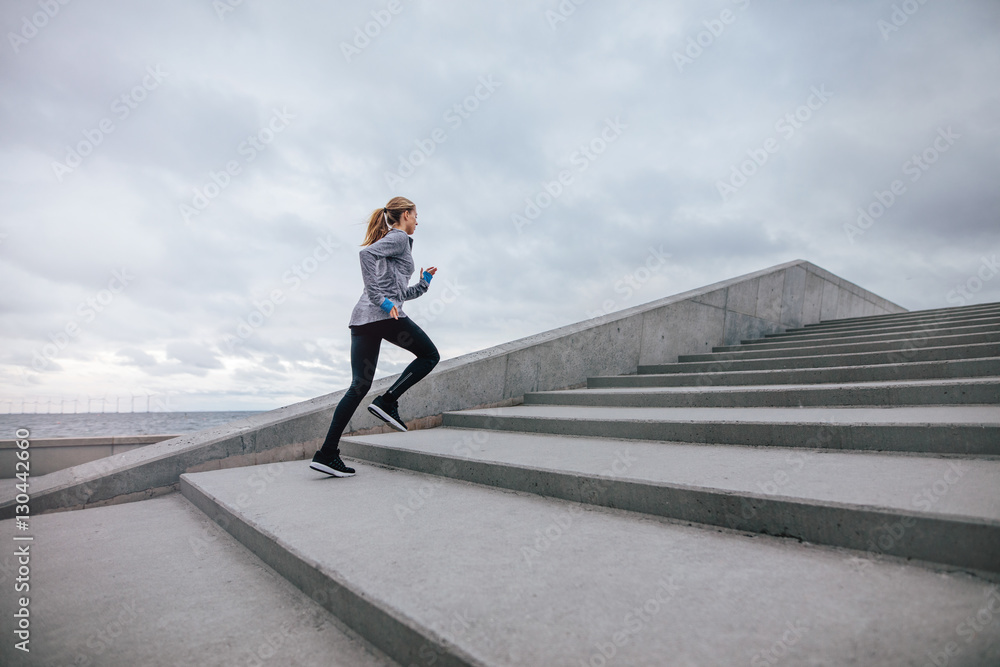 Healthy woman climbing up on stairs