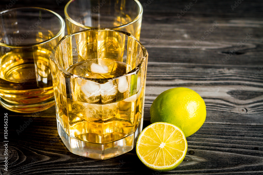 glass of whiskey on dark wooden background