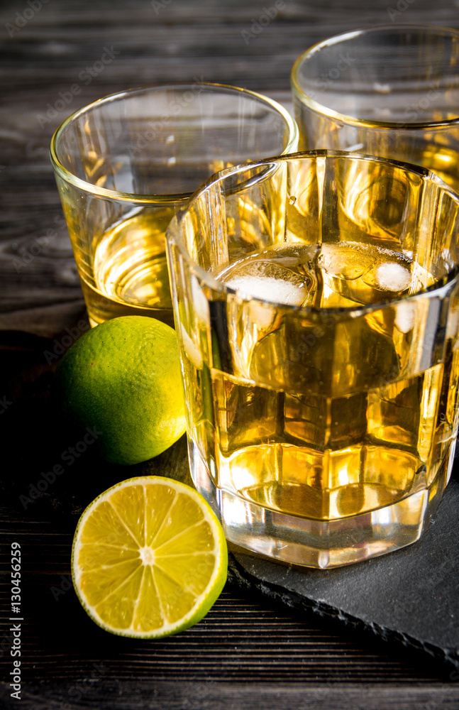 glass of whiskey on dark wooden background