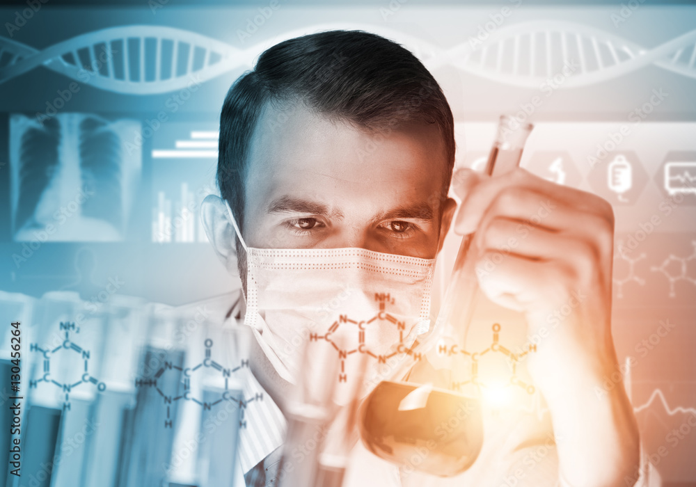 Portrait of concentrated male scientist working with reagents in laboratory