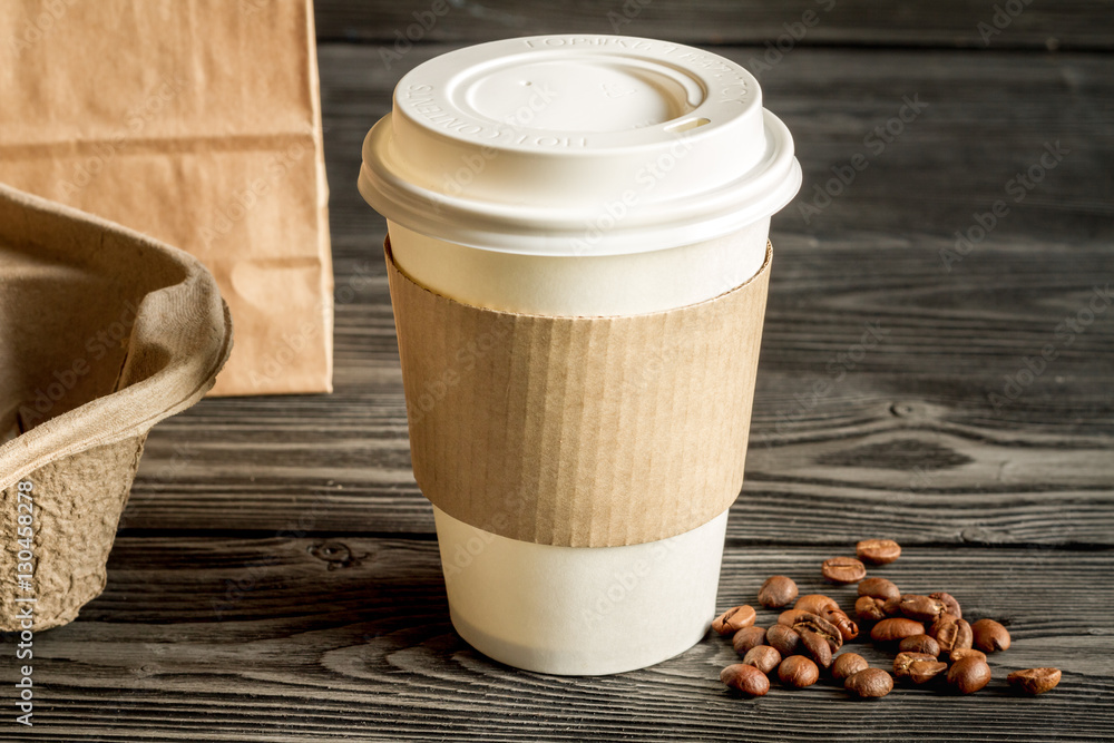 coffee cup to go at wooden background