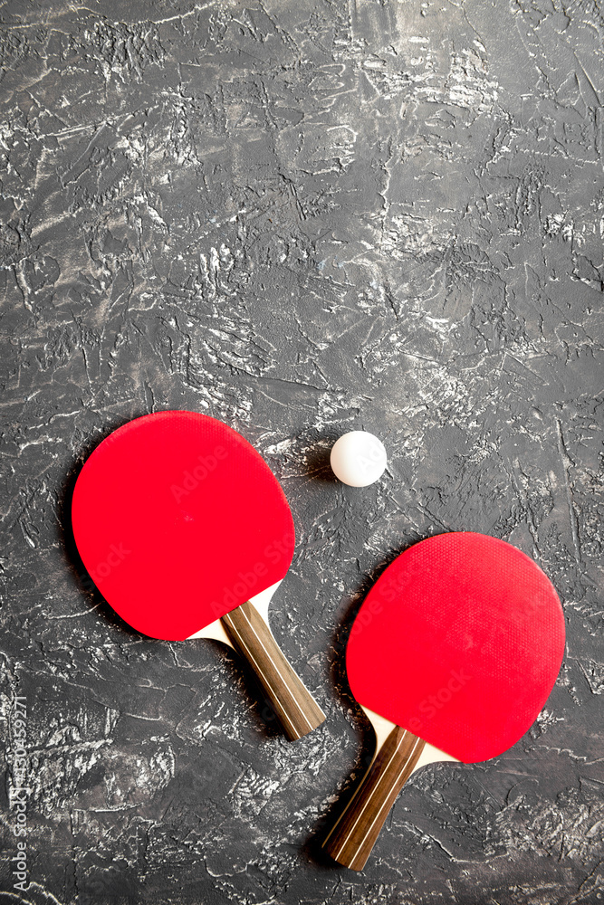 Red racket for ping pong ball gray background top view