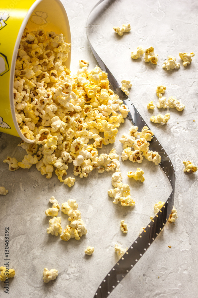 watching movie with popcorn on gray background close up