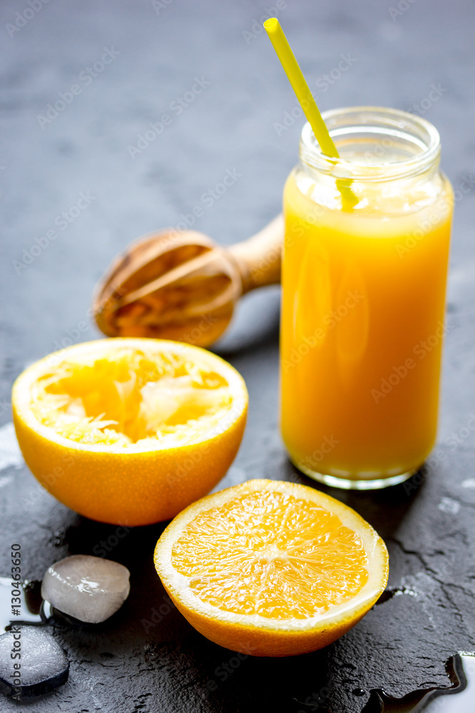 freshly squeezed orange juice on dark background