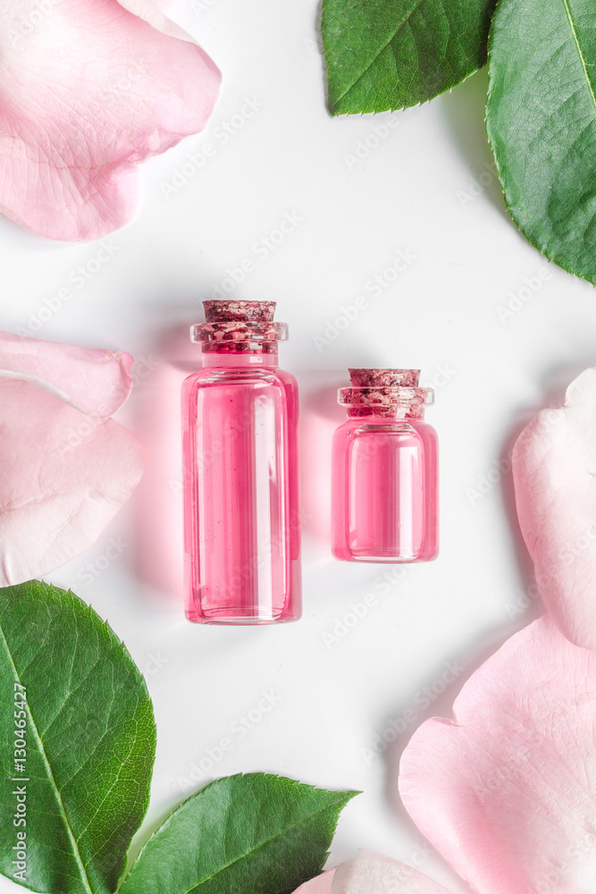 organic cosmetic with rose oil on white background top view