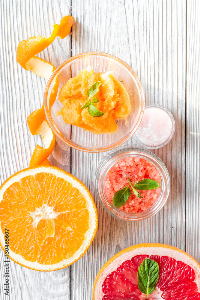 organic cosmetic with citrus on wooden background top view