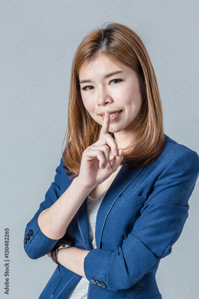 beautiful asian businesswomanwith cute smile isolated on grey ba