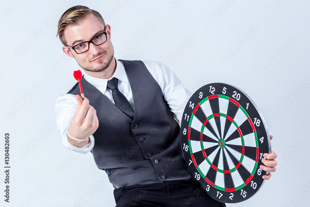 Business Man hand holding a target with darts hitting the center