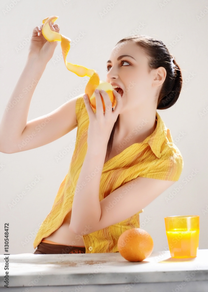 Smiling woman drinking orange juice