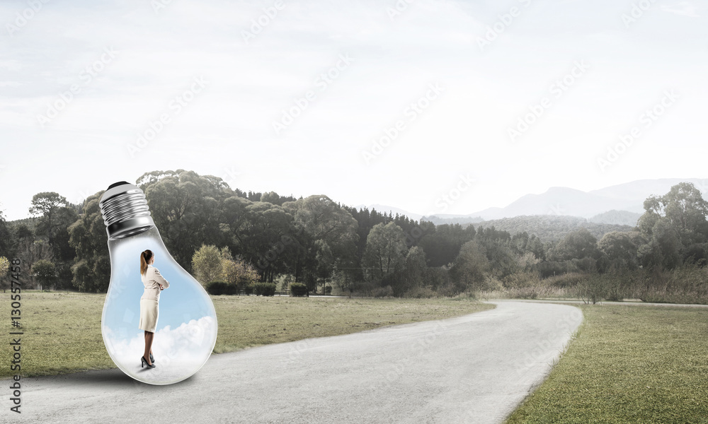 Businesswoman inside light bulb