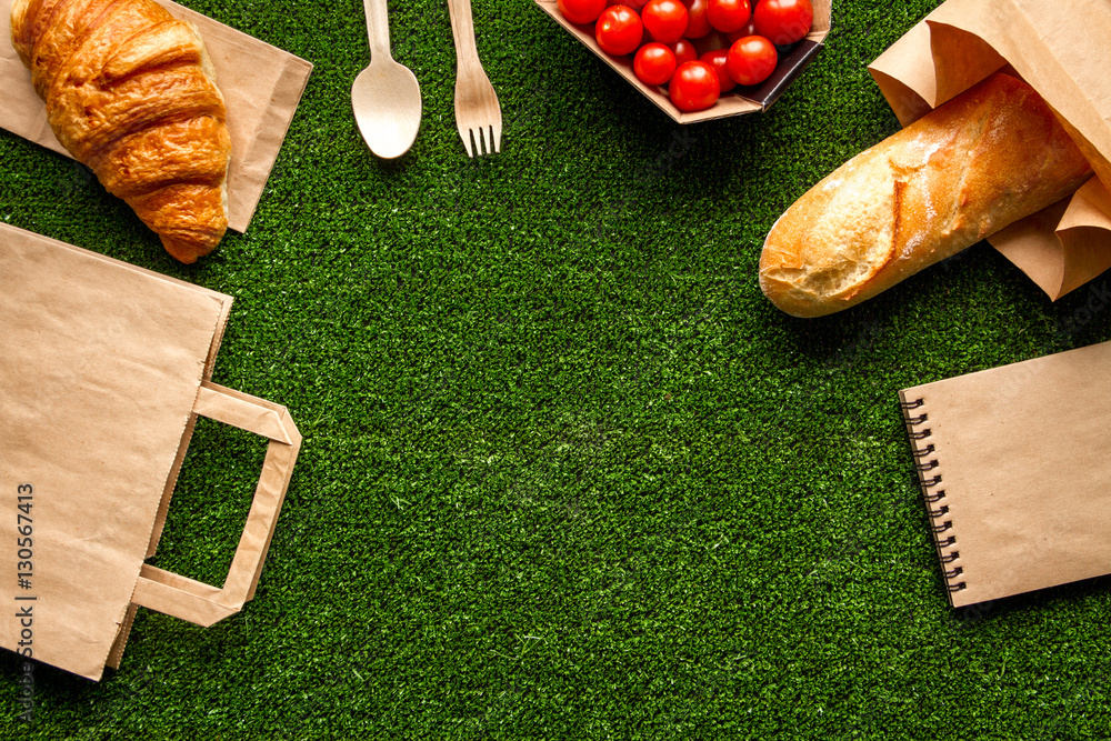 take out in paper bag on green background top view