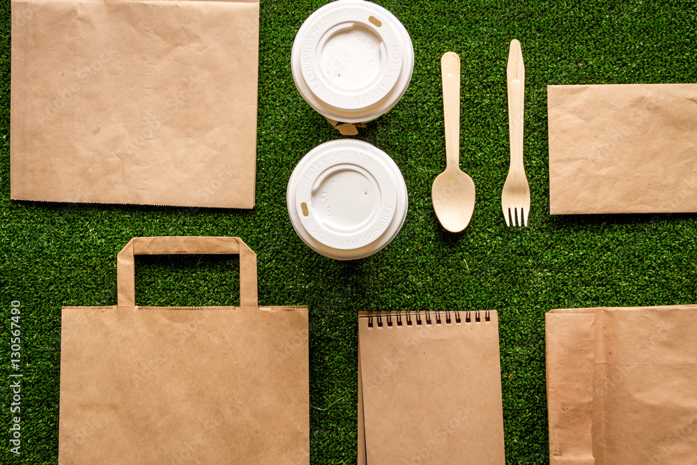 take out in paper bag on green background top view