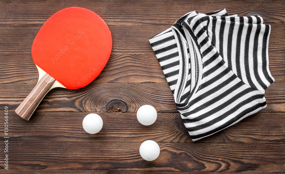 tennis racquet - fitness in the wooden background top view