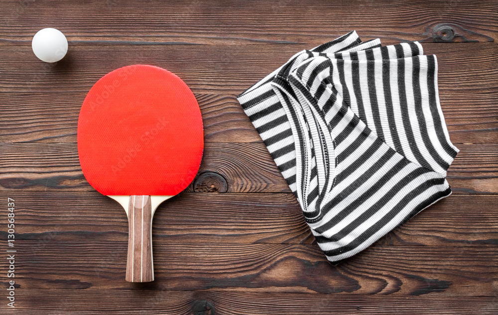 tennis racquet - fitness in the wooden background top view