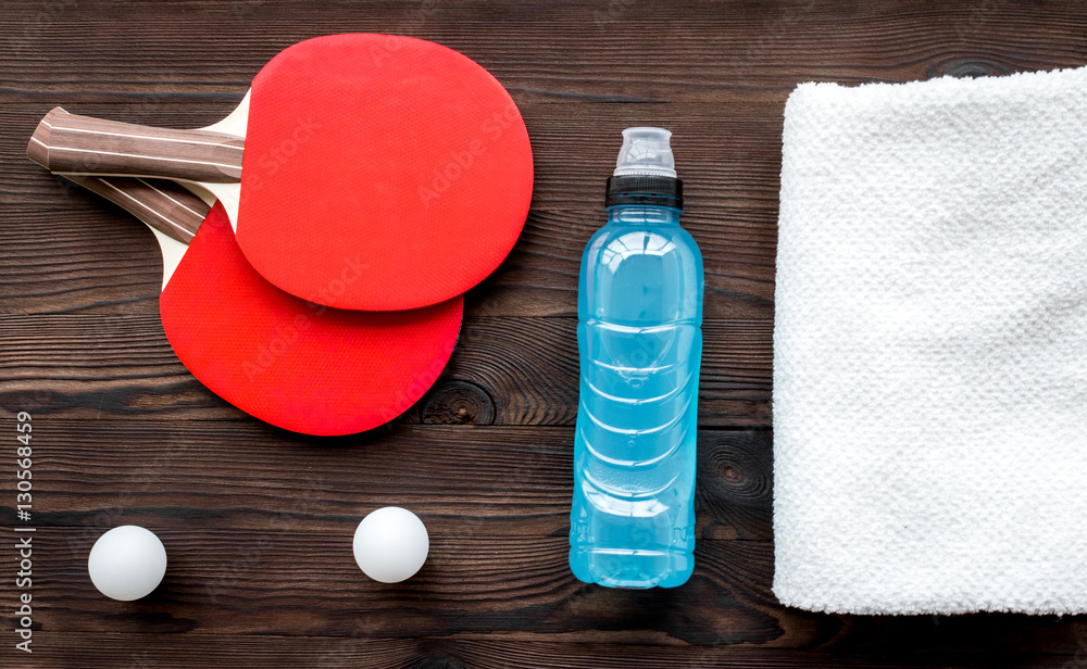 tennis racquet - fitness in the wooden background top view