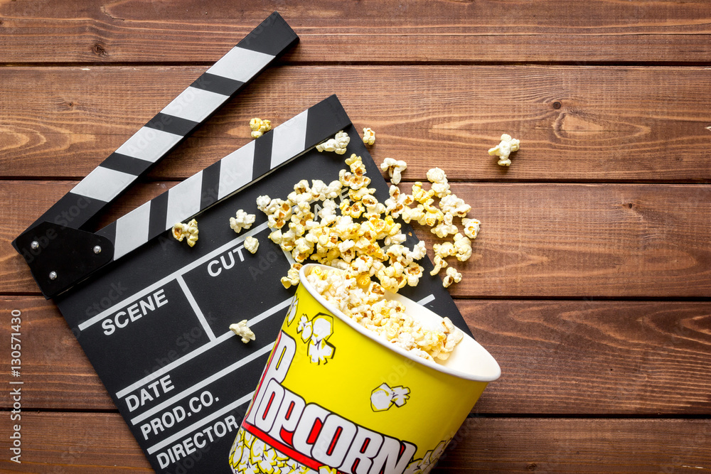 watching movie with popcorn on wooden background top view