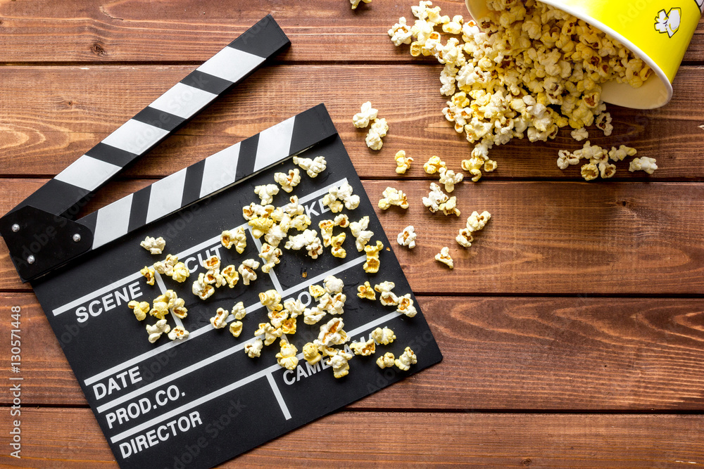 watching movie with popcorn on wooden background top view