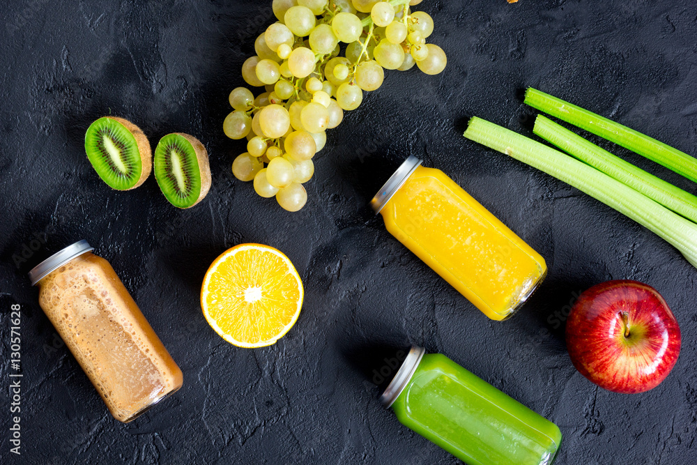 freshly squeezed juices for detox on dark background top view