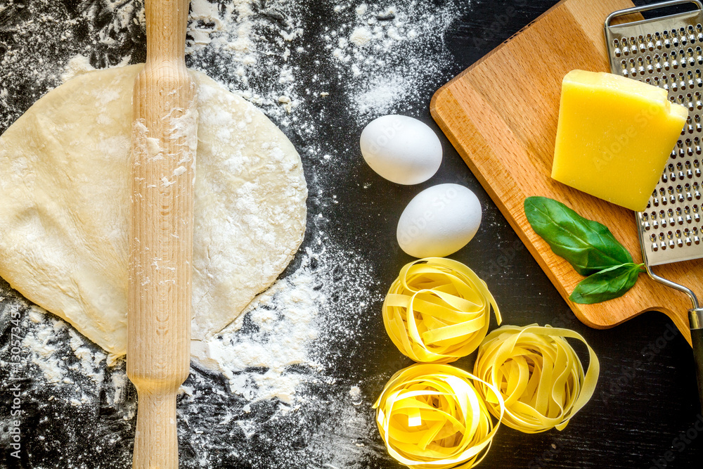 cooking process of pasta on dark background top view