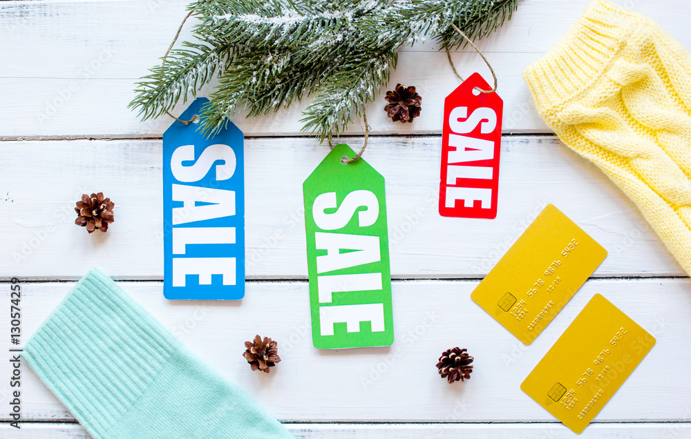 winter clothing sale on wooden background top view