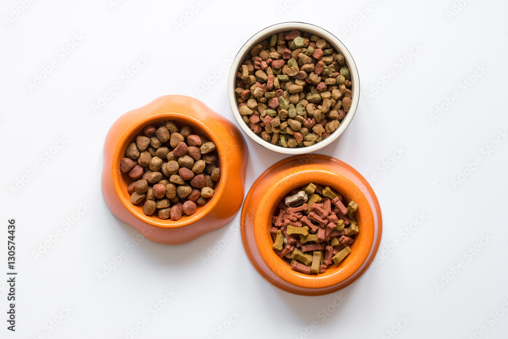 dry pet food in bowl on white background top view