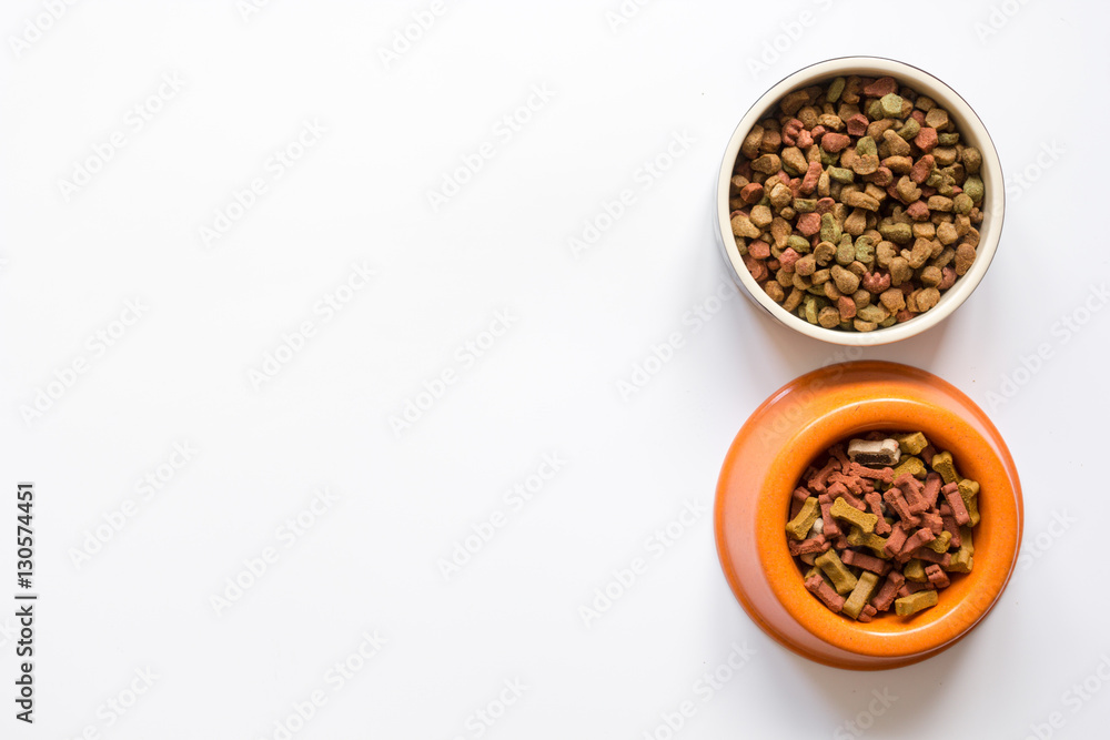 dry pet food in bowl on white background top view