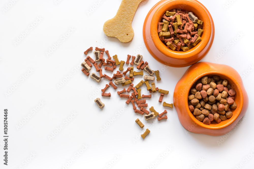 dry dog food in bowl on white background top view