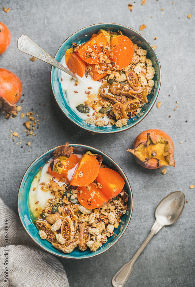 Healthy breakfast. Close-up of oatmeal, quinoa granola with yogurt, dried fruit, seeds, honey, fresh