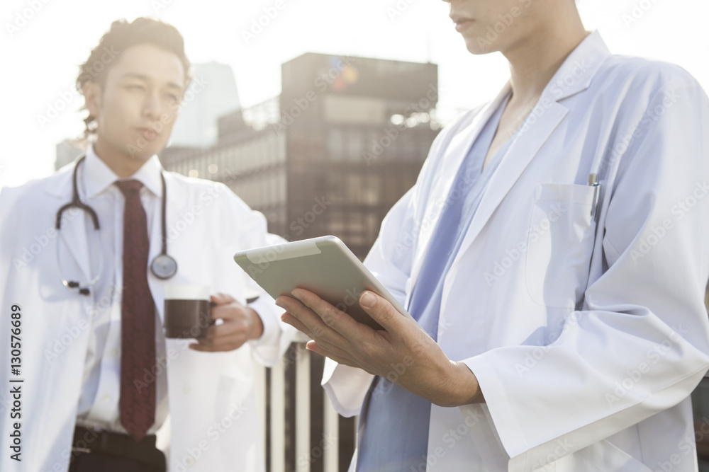 Two doctors are talking on the rooftop