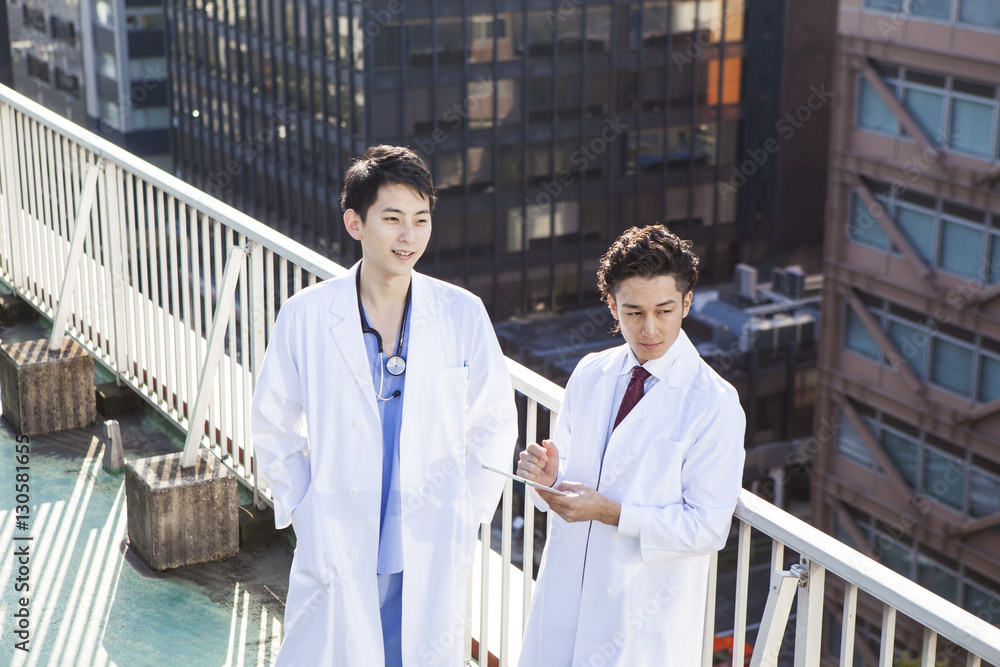 Two male doctors on the roof of the hospital