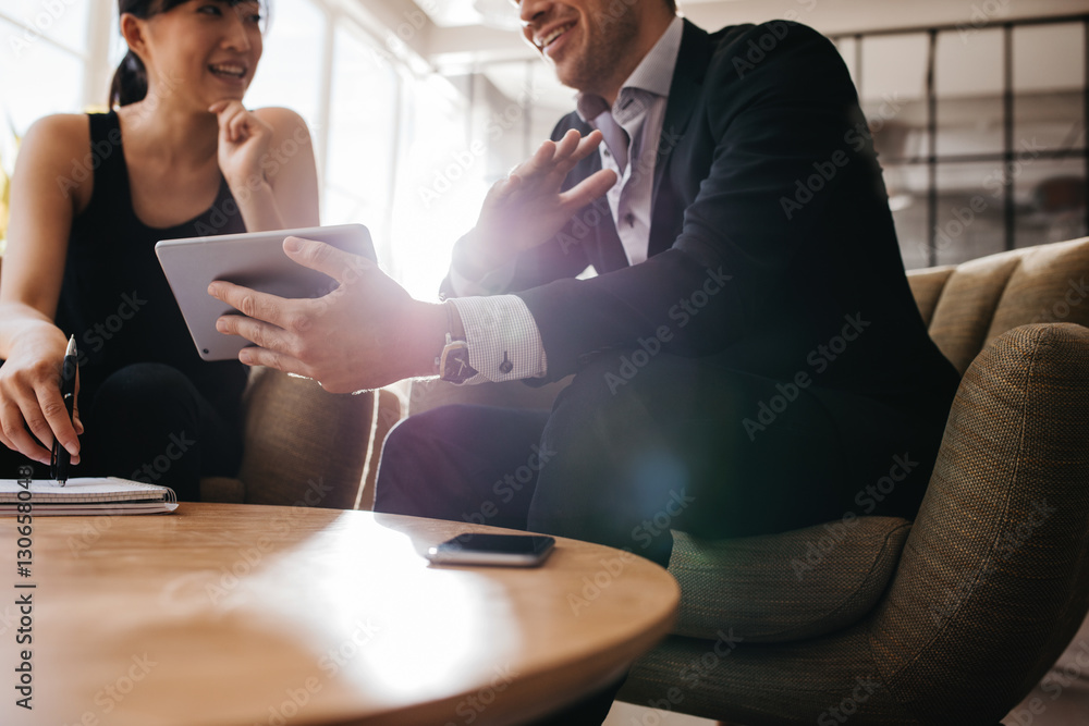 Business partners using digital tablet