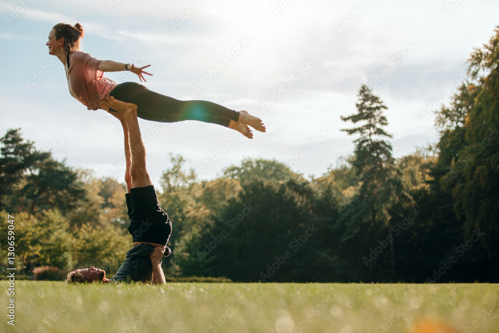 Fit young couple practising acroyoga