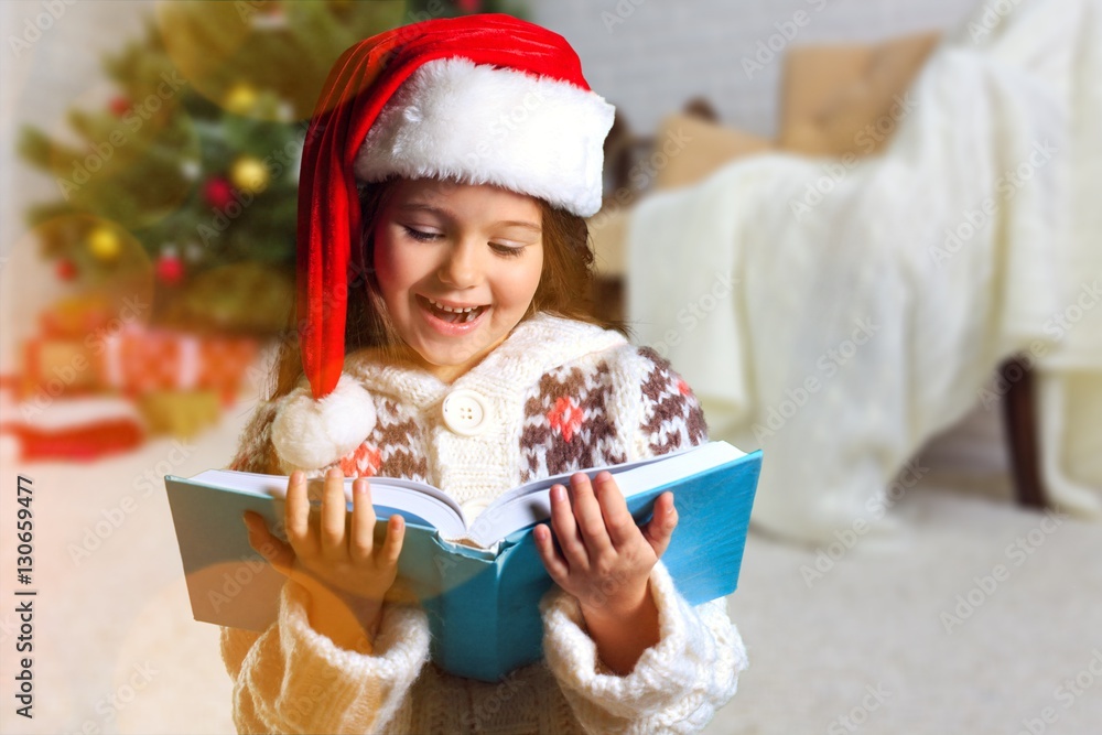 Surprised child opening book.