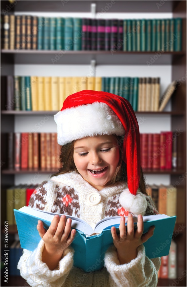 Surprised child opening book.