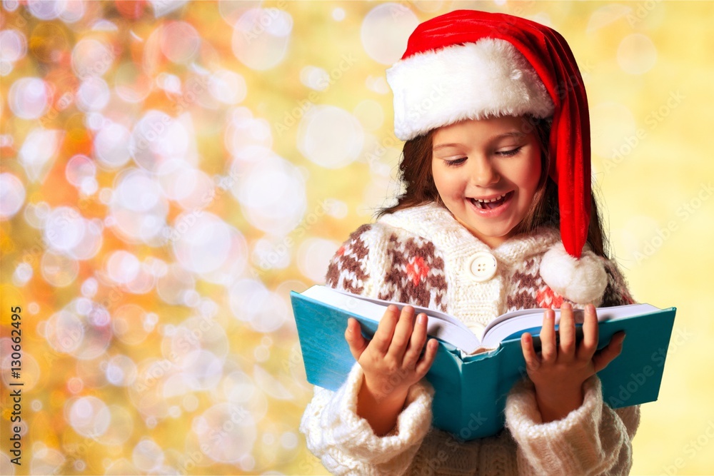 Surprised child opening book.