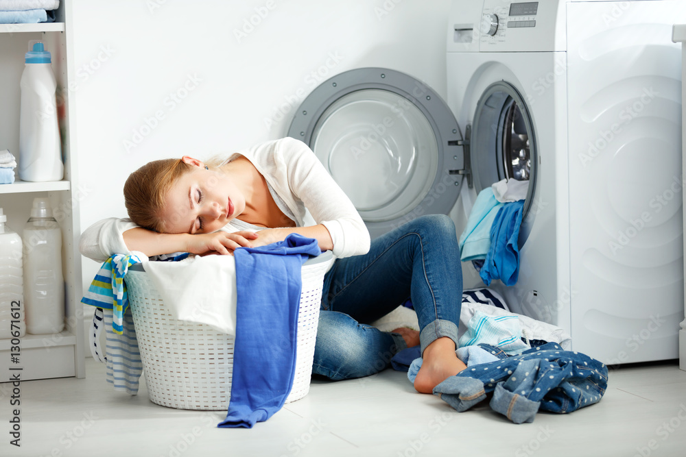 tired unhappy woman housewife is engaged in the laundry,